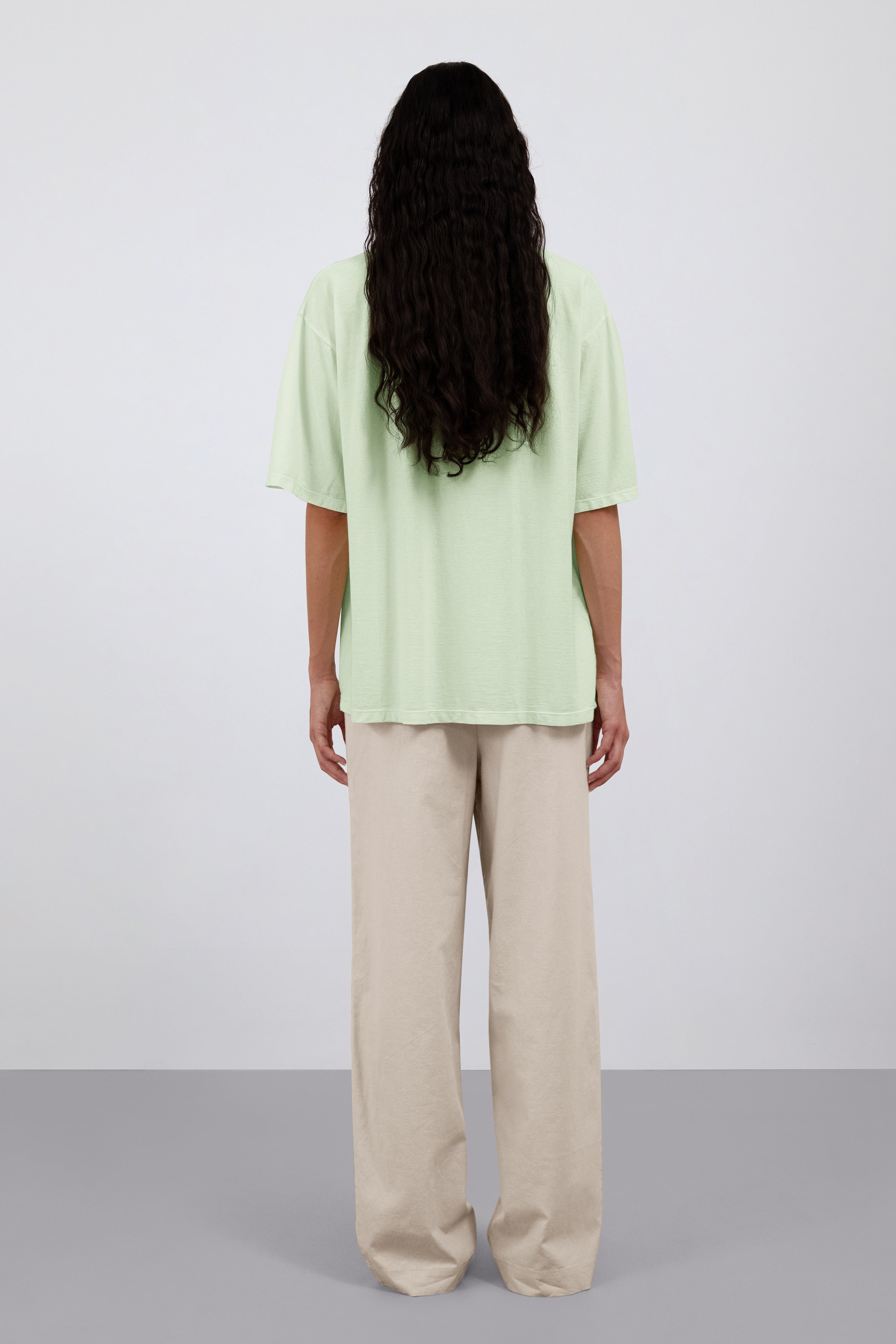 The Alex in Beige. 50% linen with 48% cotton with 2% elastane. Shown on model with The Lara in Lime. Back view.