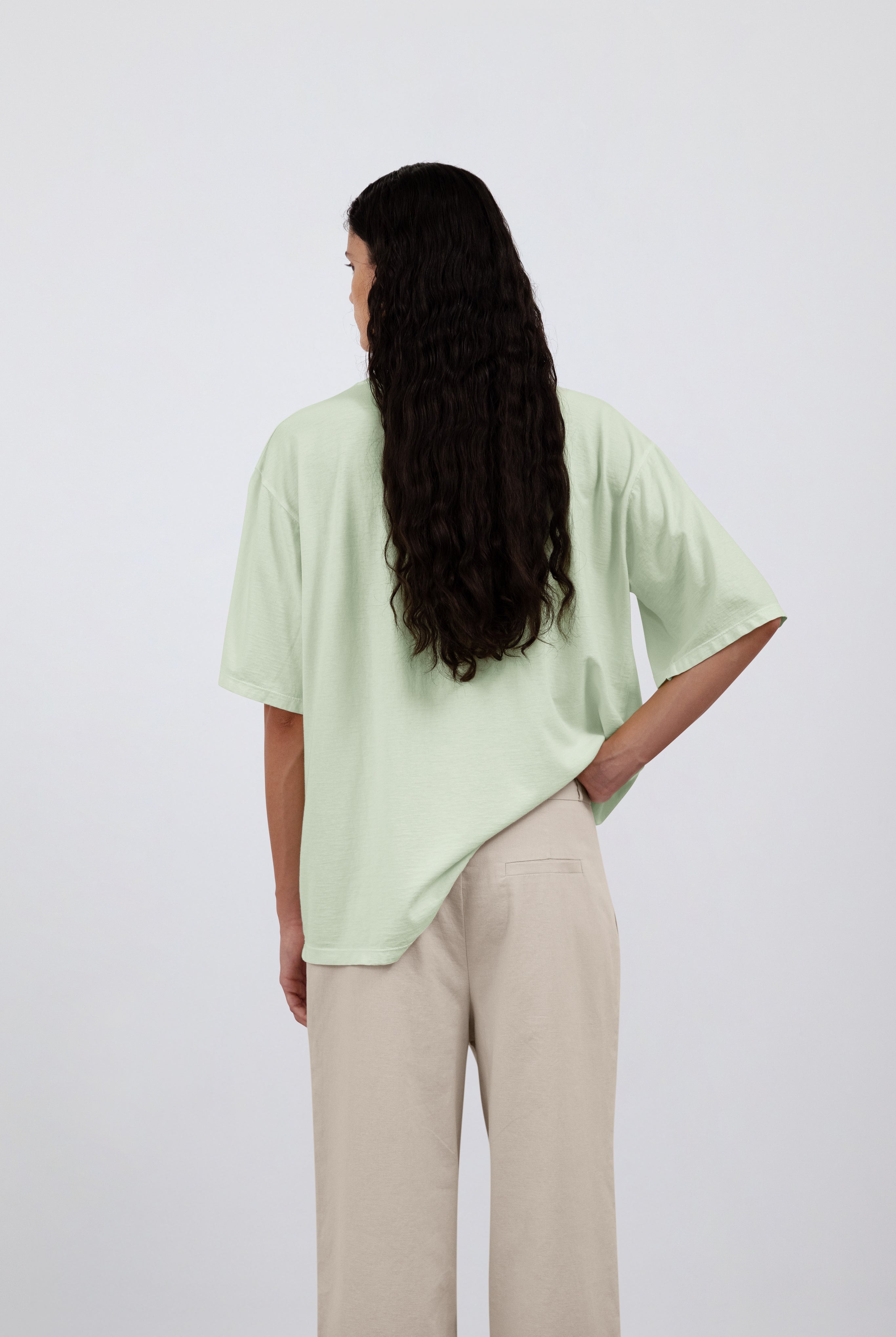 The Alex in Beige. 50% linen with 48% cotton with 2% elastane. Shown on model with The Lara in Lime. Back view.