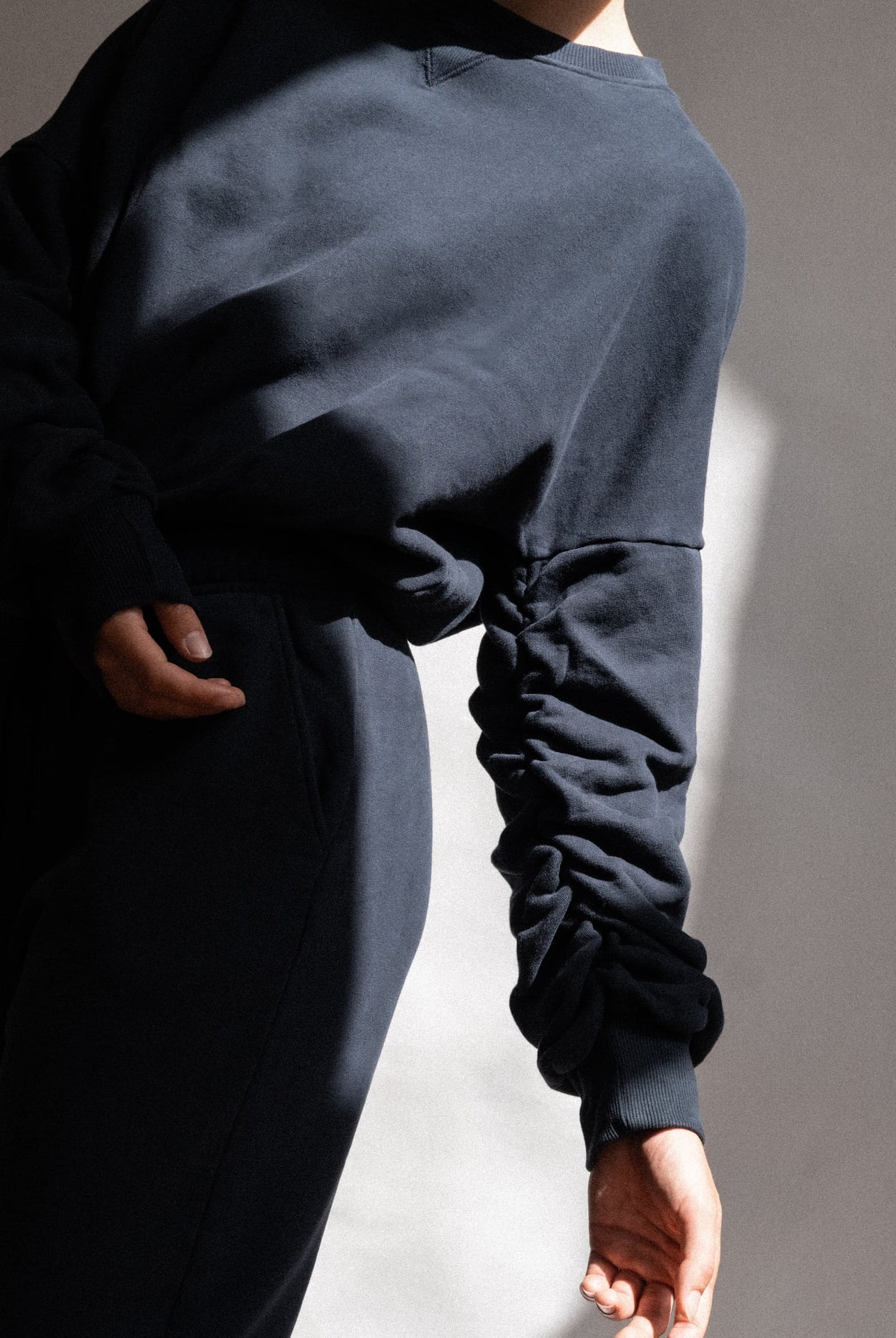 The Blake cropped sweatshirt in navy on model, organic cotton fleece