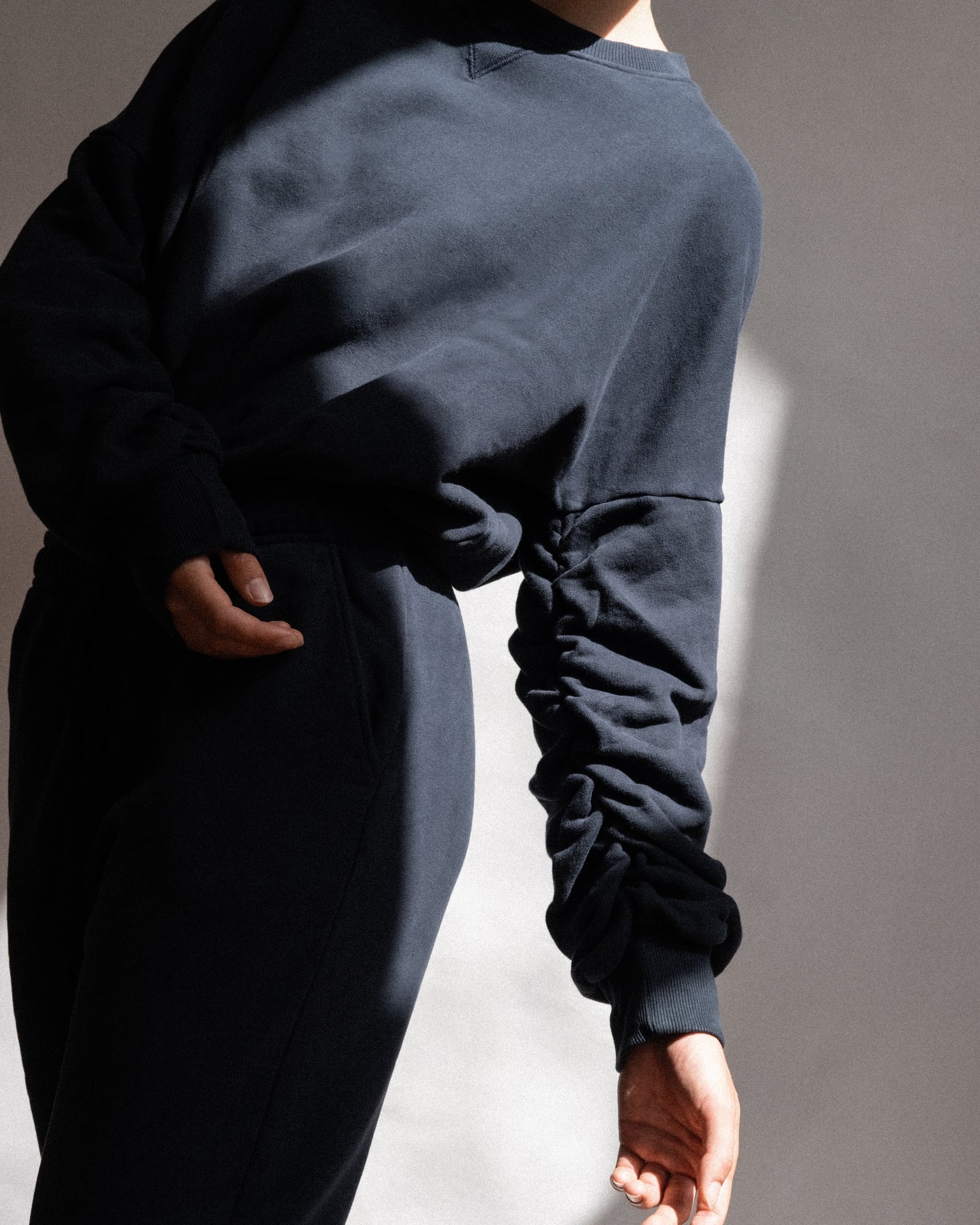 The Blake cropped sweatshirt in navy on model, organic cotton fleece