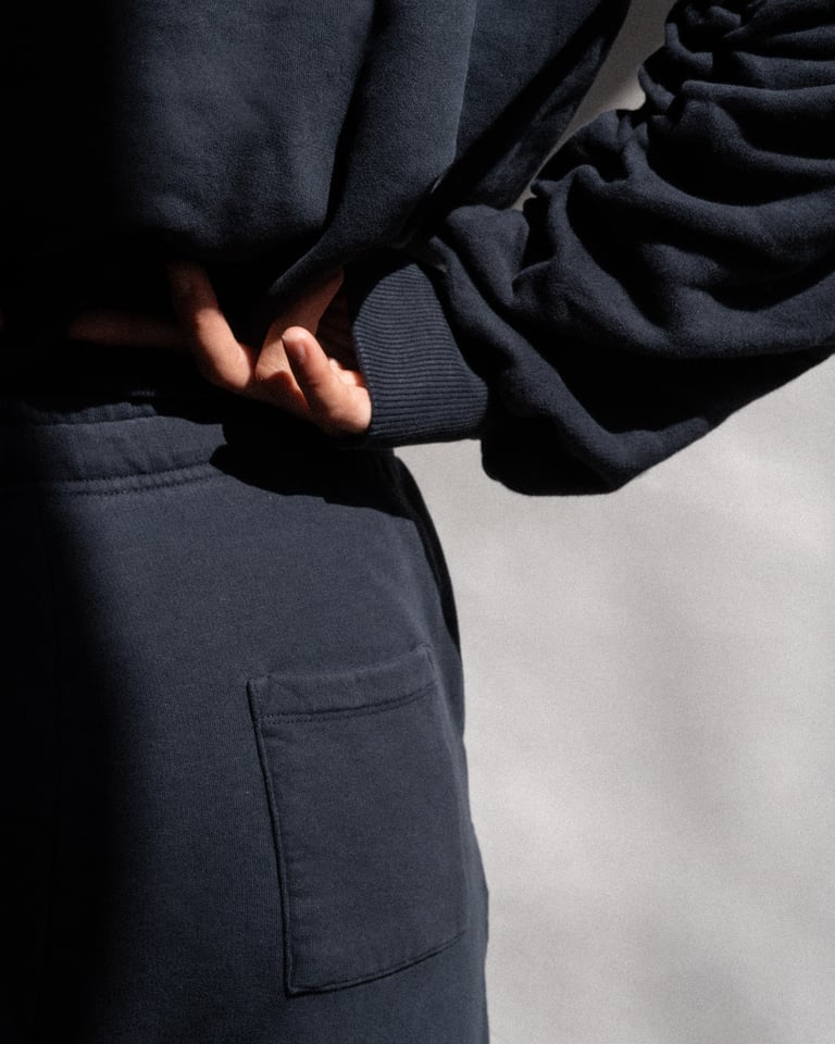 The Abby tapered sweatpants in navy on model, organic cotton fleece