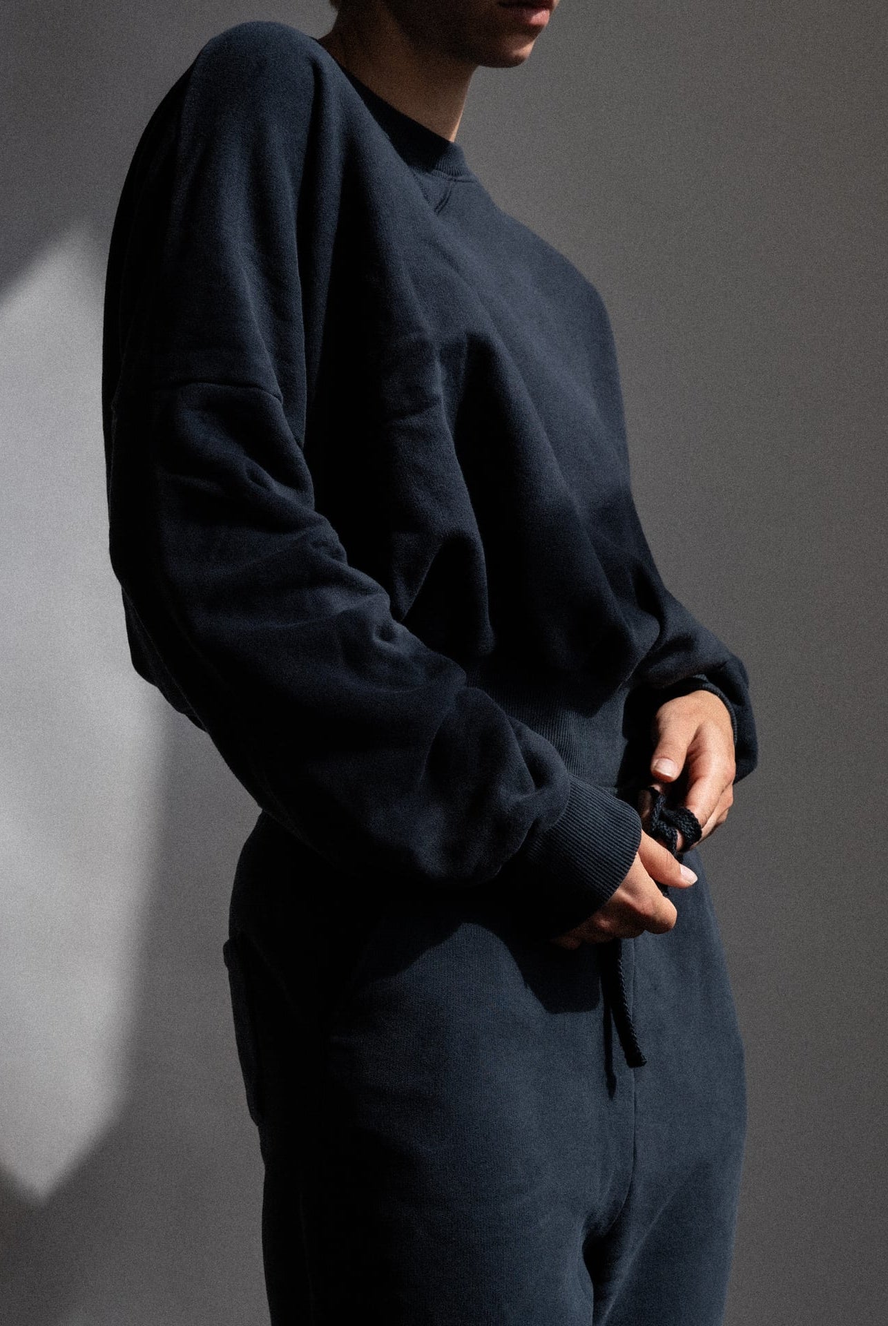 The Blake navy sweatshirt detail view on model, brushed organic cotton