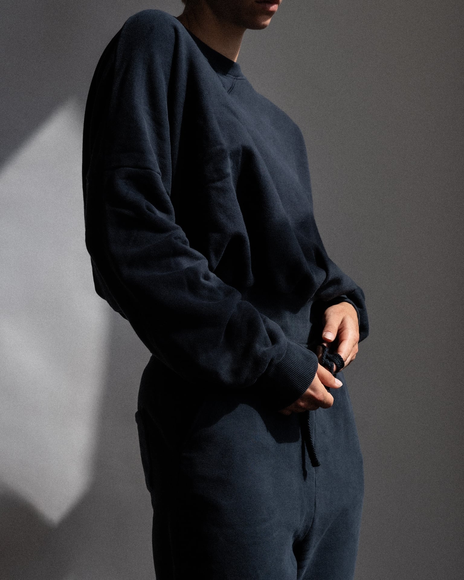 The Blake navy sweatshirt detail view on model, brushed organic cotton