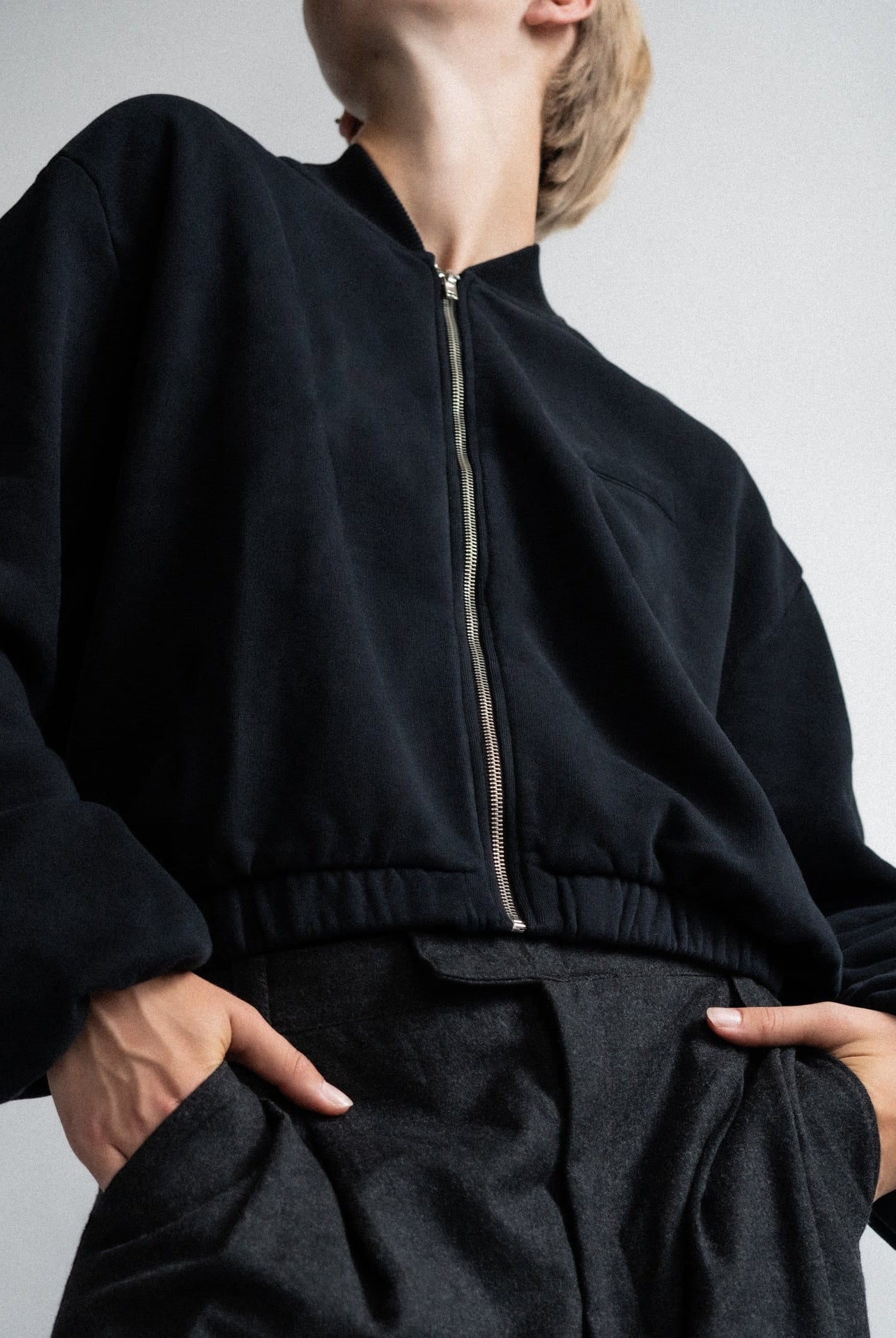 The Pippa essential black bomber detail view showing gathered cuff, brushed organic cotton