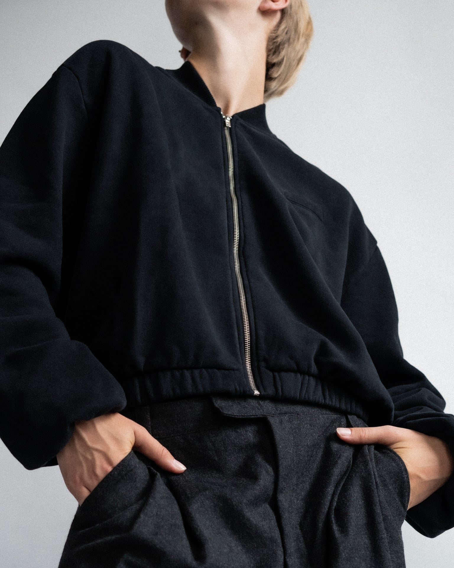 The Pippa essential black bomber detail view showing gathered cuff, brushed organic cotton