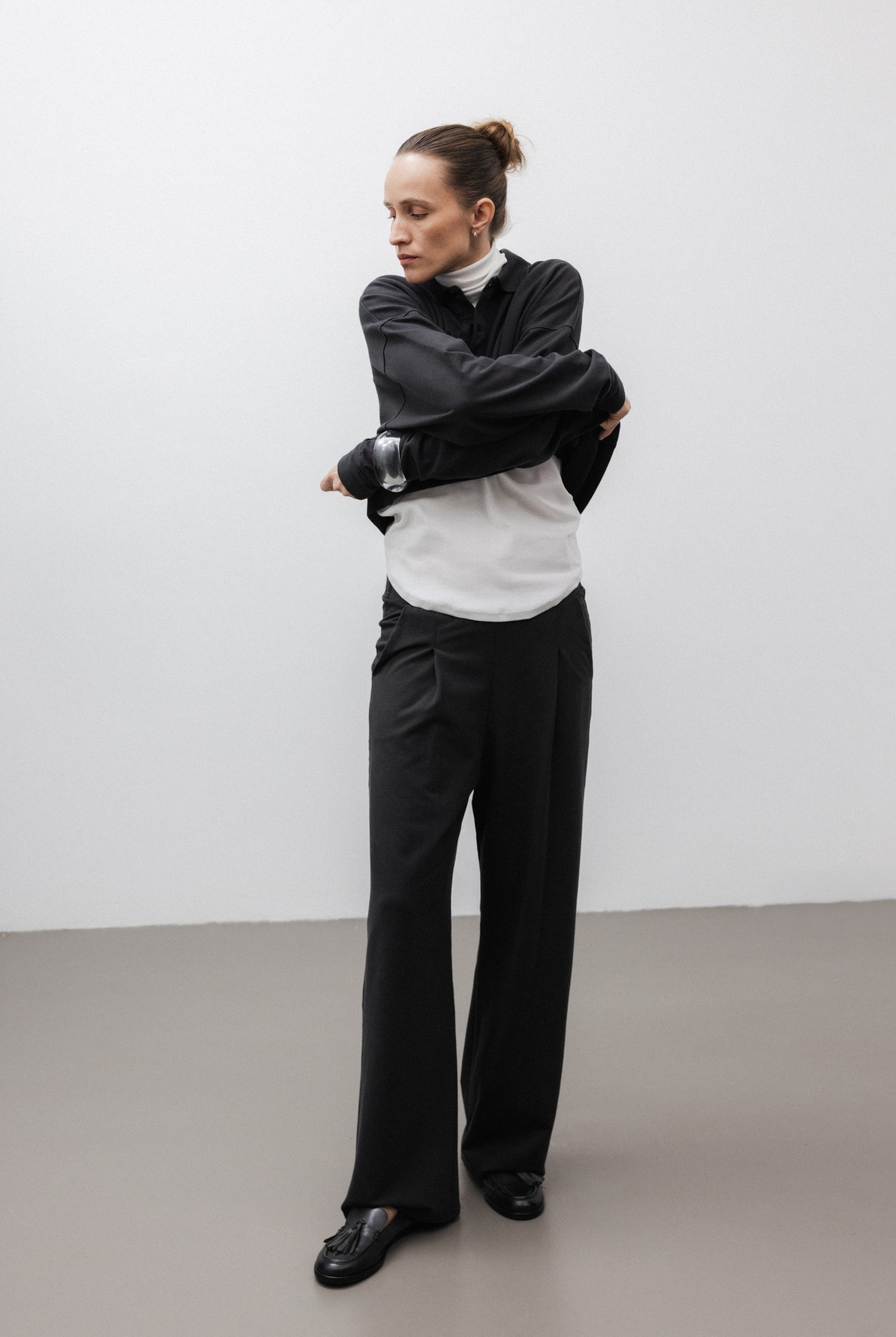 The Theresa in Off-White. Ribbed Turtleneck. 95% organic cotton with 5% elastane. GOTS. Shown on model with The Remi in Pitch Black.