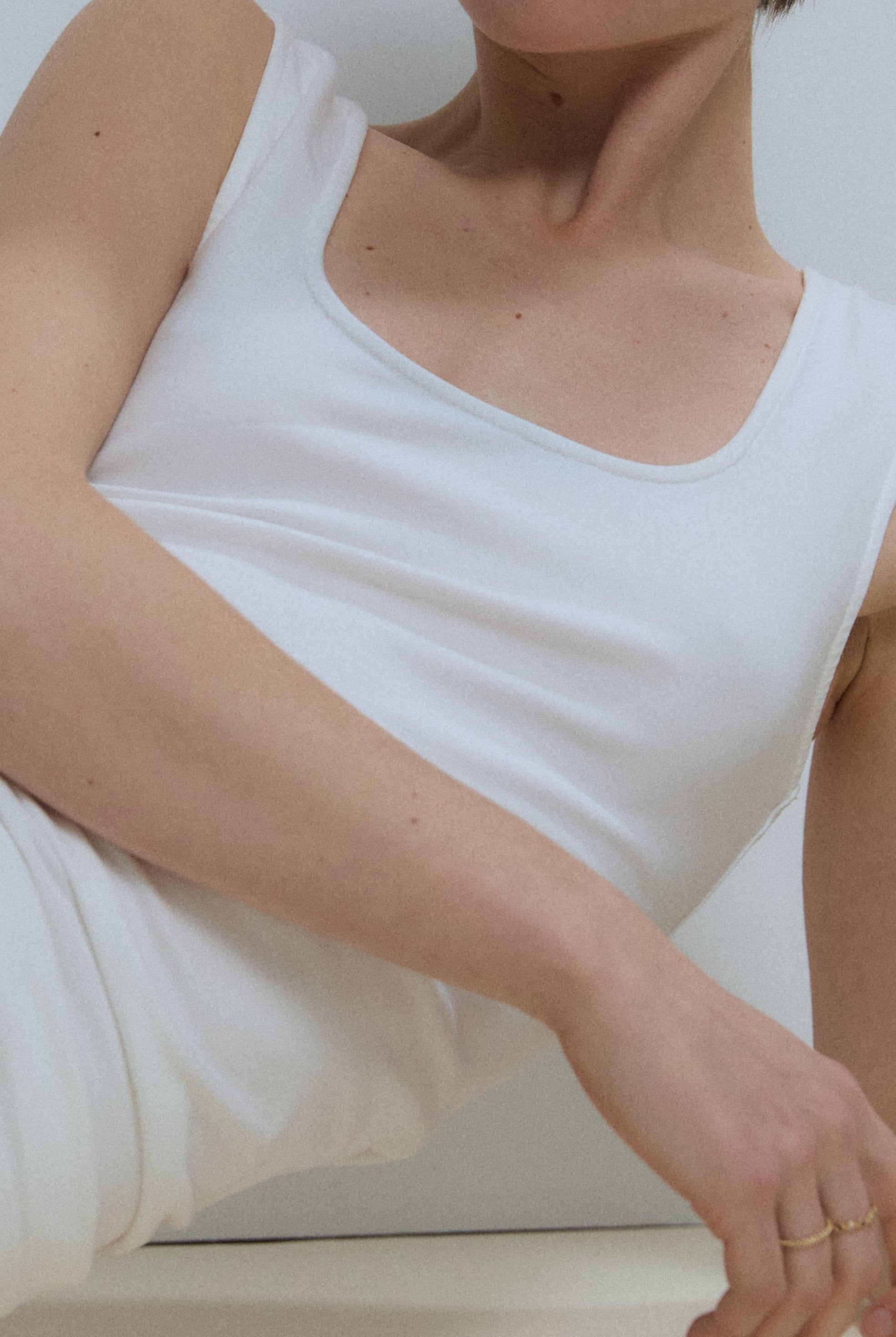 The Uma top in off-white on model, 95% organic cotton 5% elastane