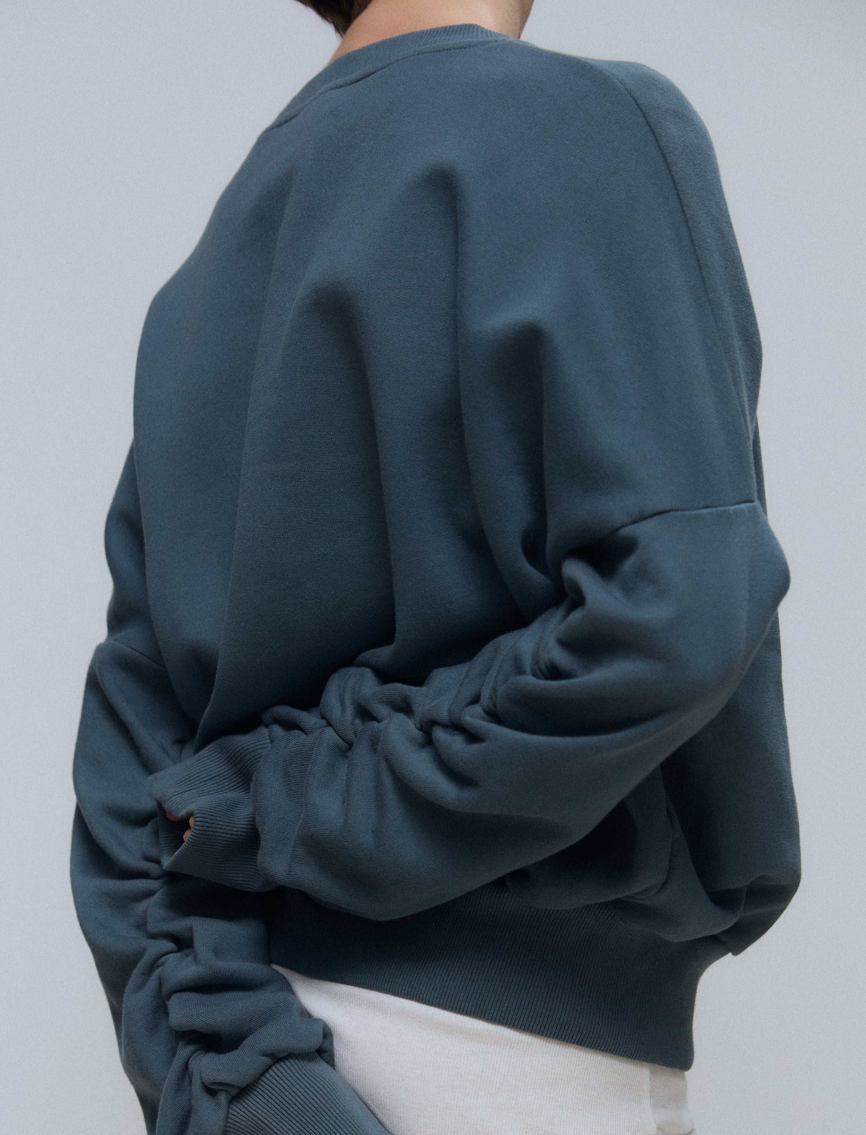 The Blake cropped sweatshirt in stone on model, organic cotton fleece