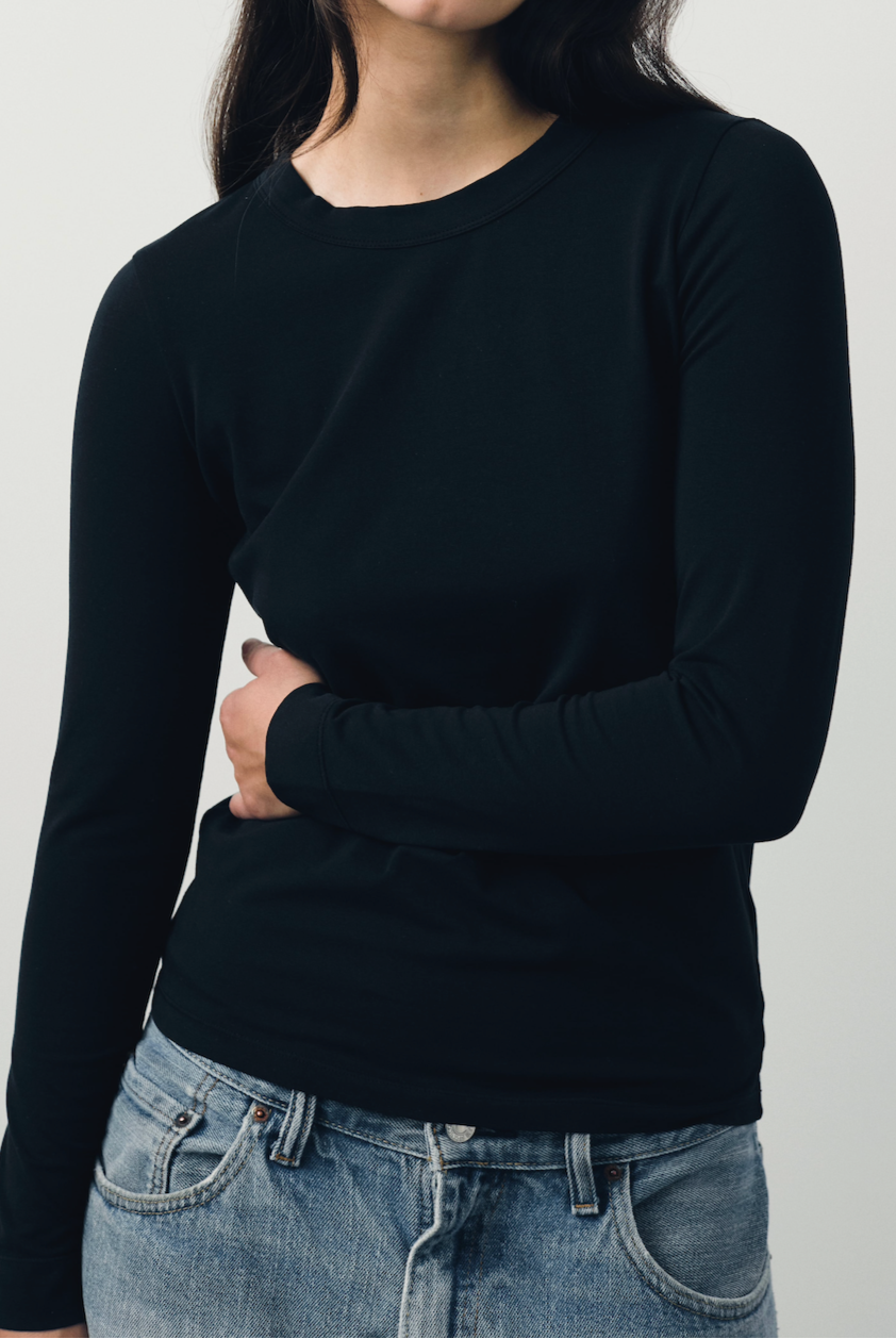The Nora fitted long sleeve in essential black on model, organic cotton with stretch