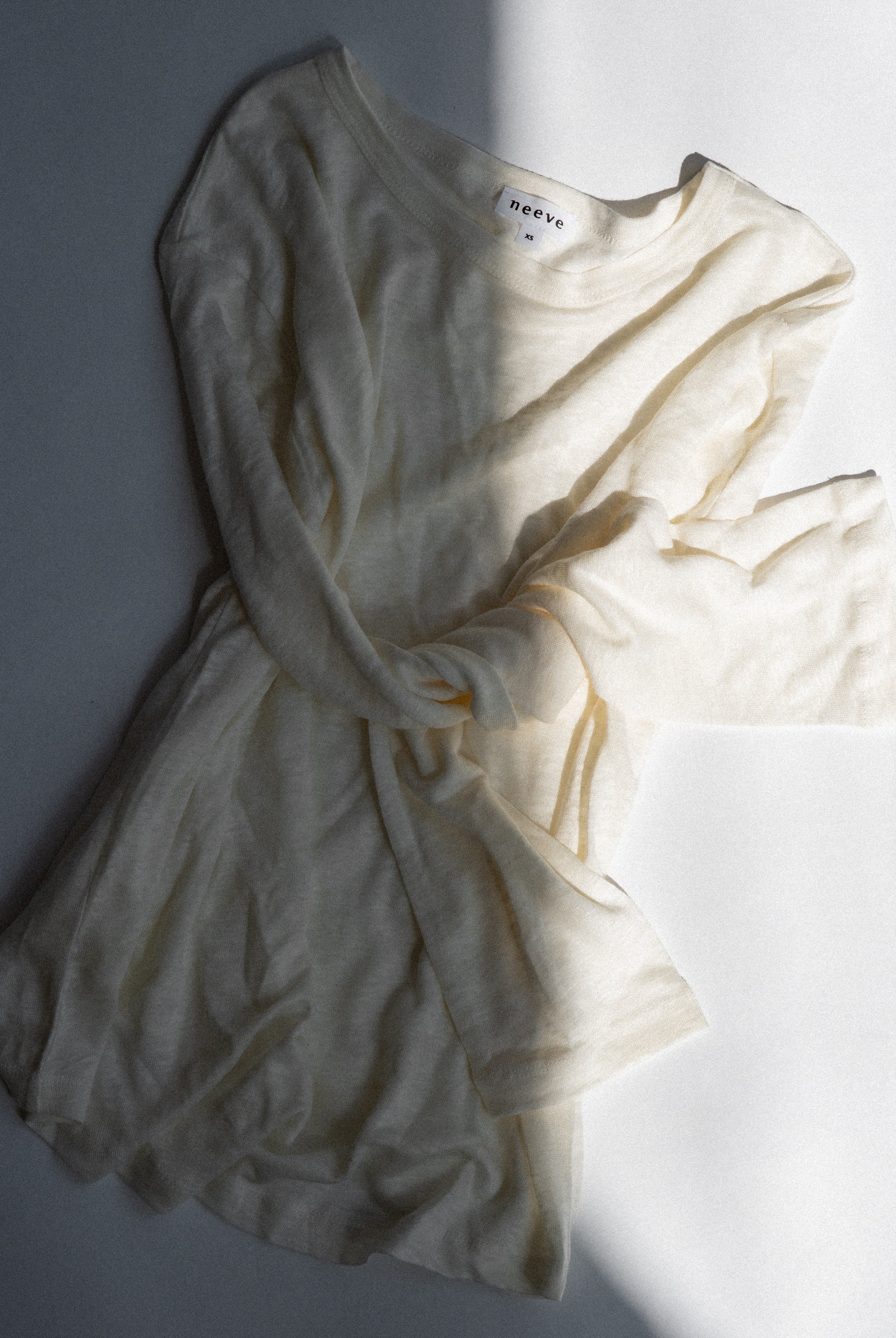 The Reese linen top in off-white - front view, breathable natural fabric
