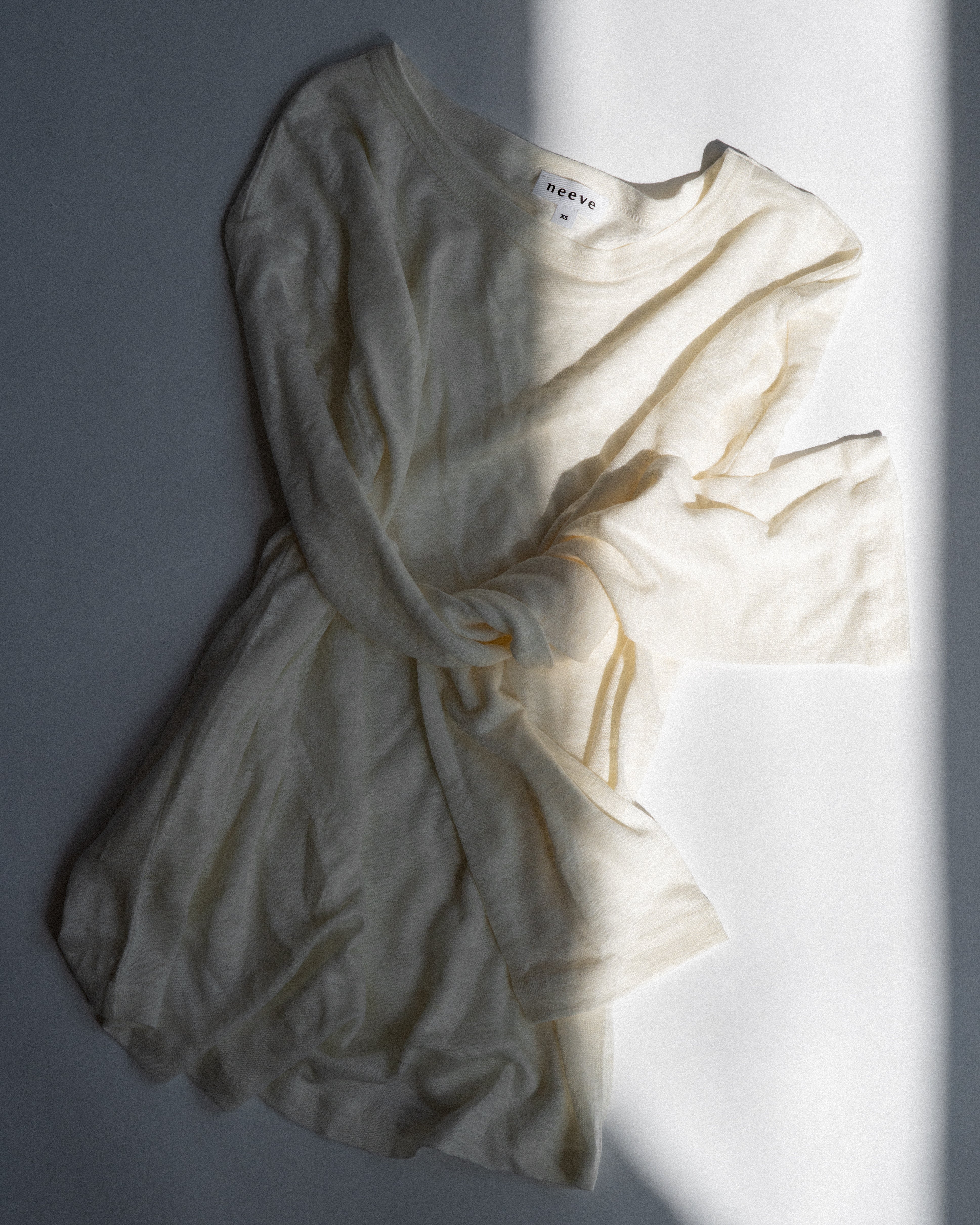 The Reese linen top in off-white - front view, breathable natural fabric