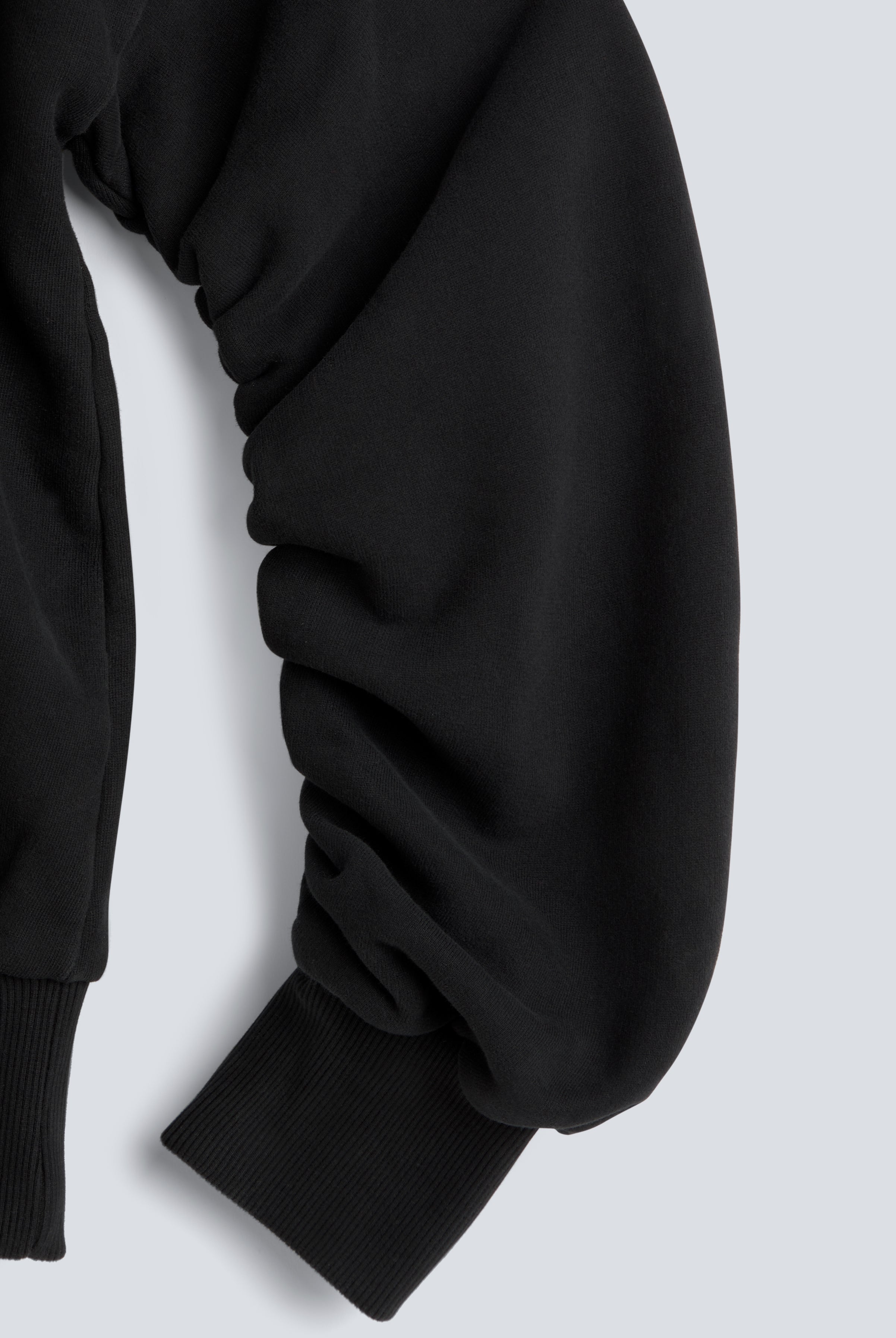 The Blake essential black sweatshirt twisted sleeve detail, signature design feature