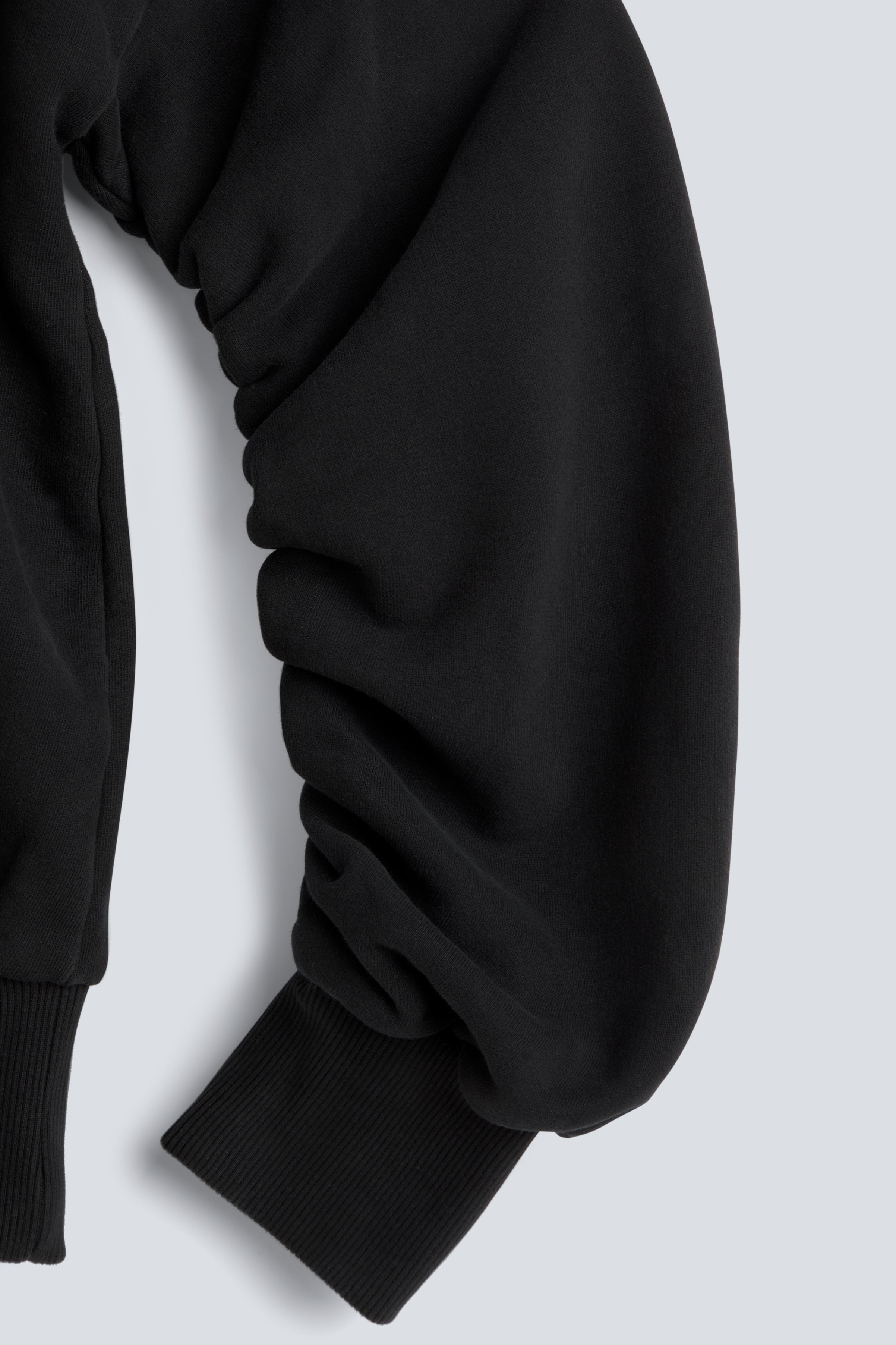 The Blake essential black sweatshirt twisted sleeve detail, signature design feature