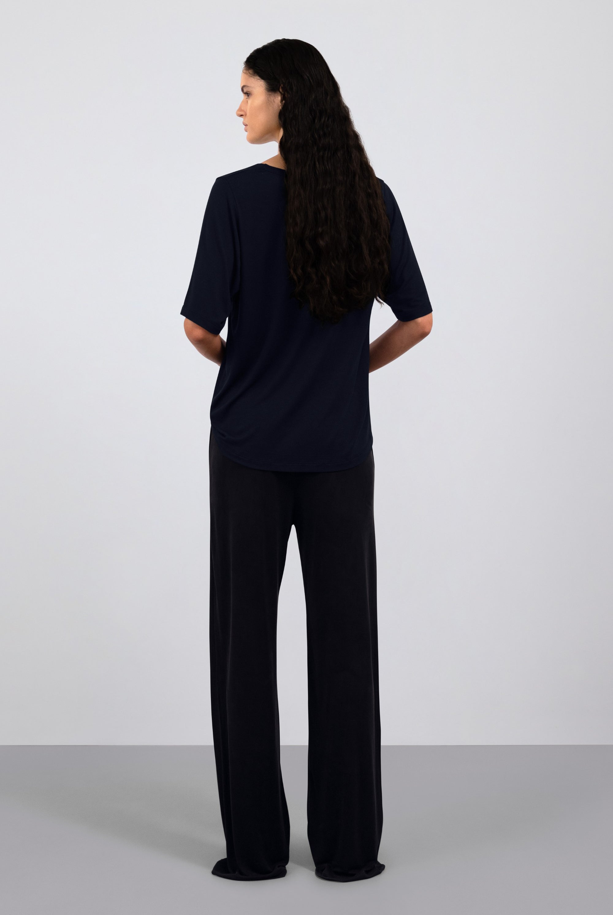 The Mare in Essential Black. 95% Micromodal with 5% elastane. Shown on model with The Sam in Essential Black. Back view.