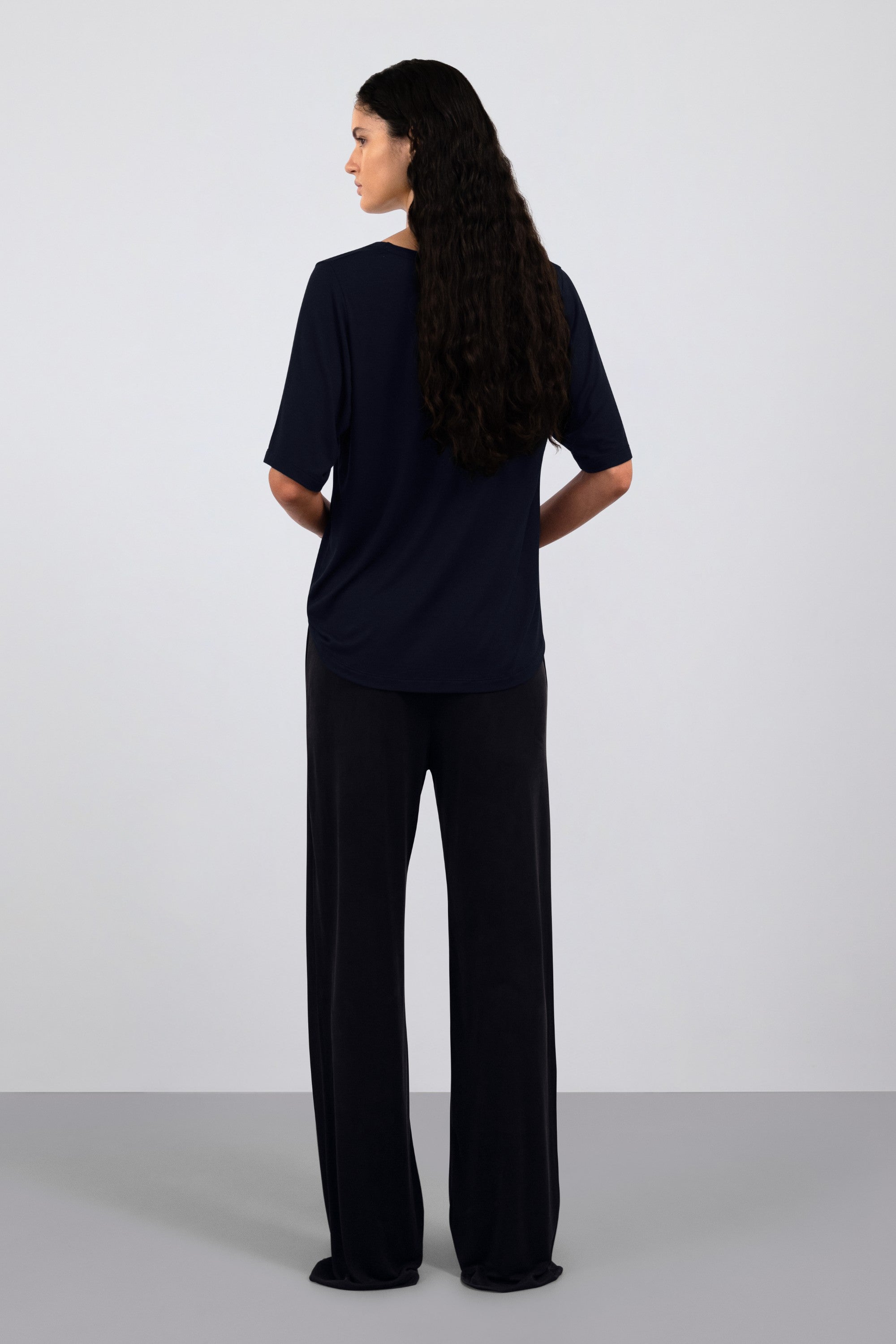 The Mare in Essential Black. 95% Micromodal with 5% elastane. Shown on model with The Sam in Essential Black. Back view.