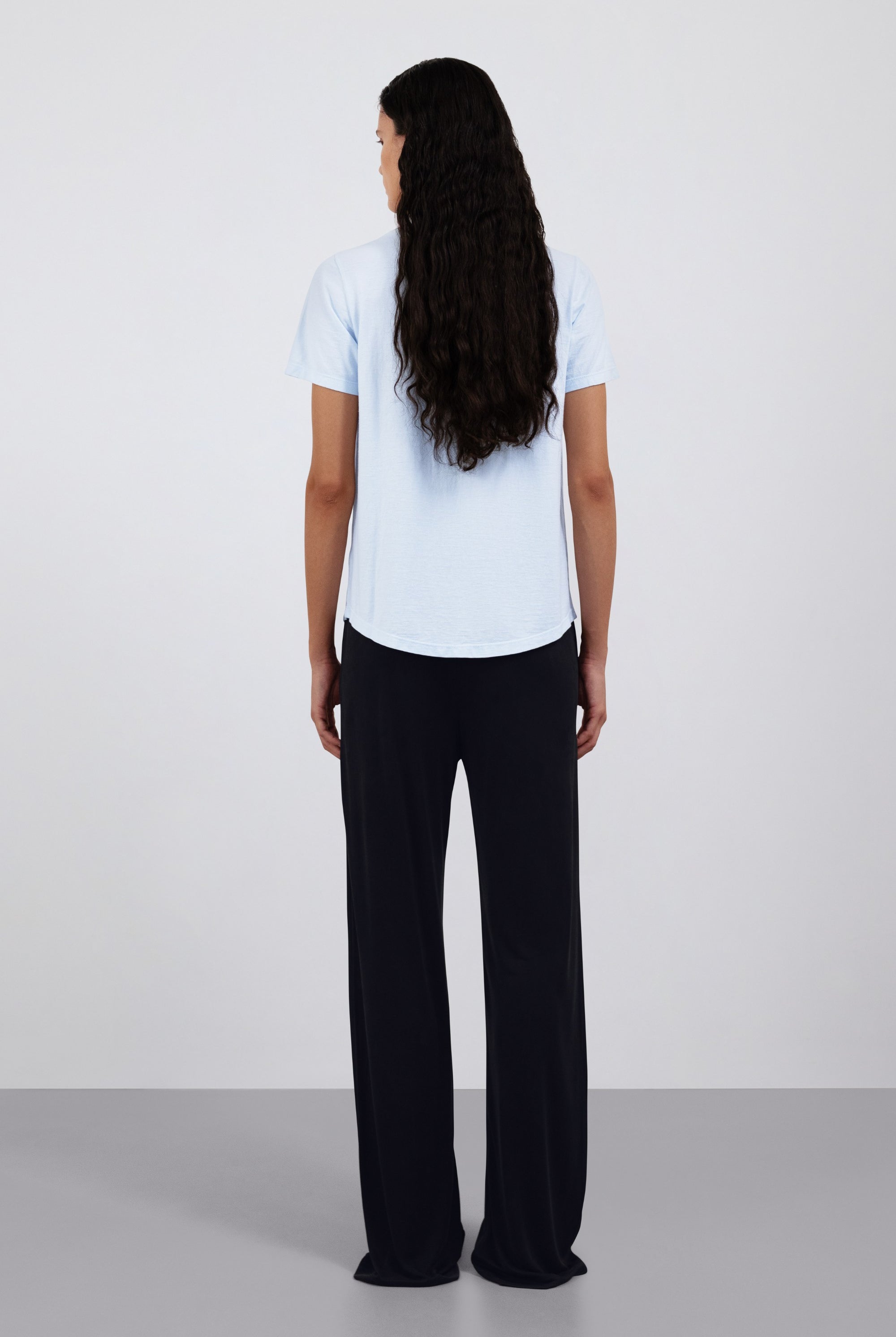 The Sam Essential Black. 100% Lyocell shown on model with The Michelle in Ice Blue. Back view.