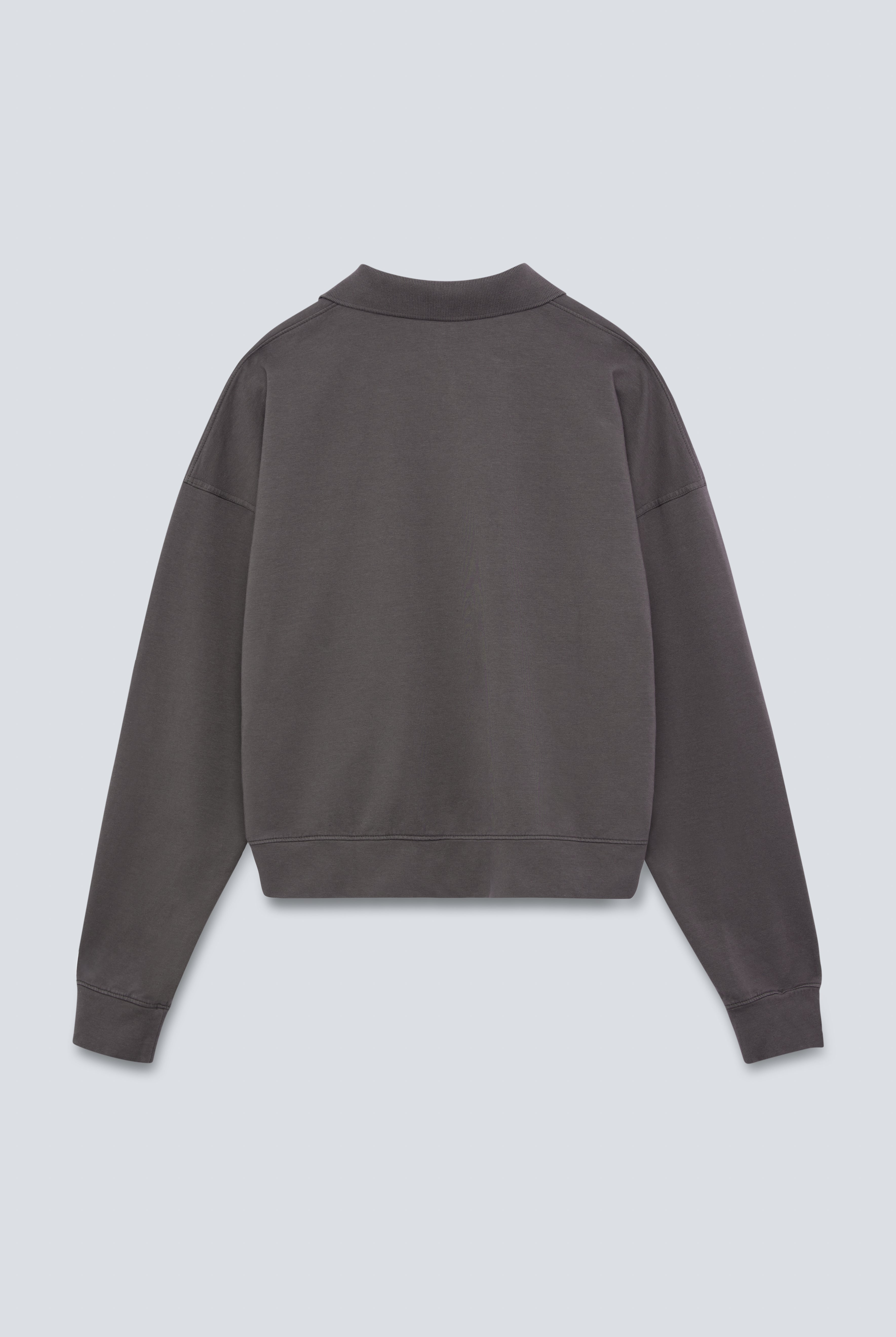 The Remi in Pitch Black. Polo long sleeve and a boxy shape. Made from 100% organic cotton babyfleece. GOTS. Back View.