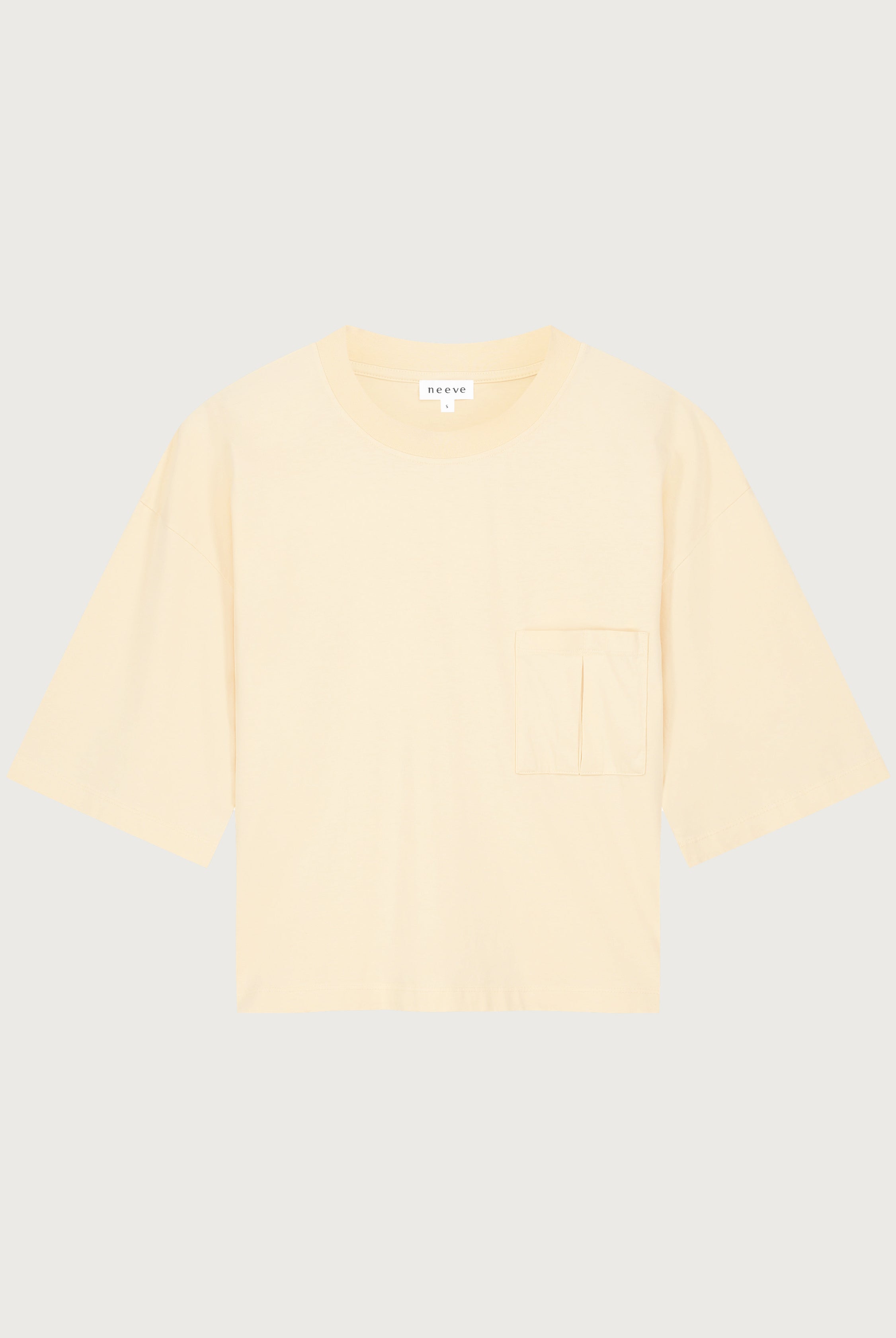 The Tess dropped shoulder tee in apricot front view, pocket detail, 180g organic cotton made in Portugal