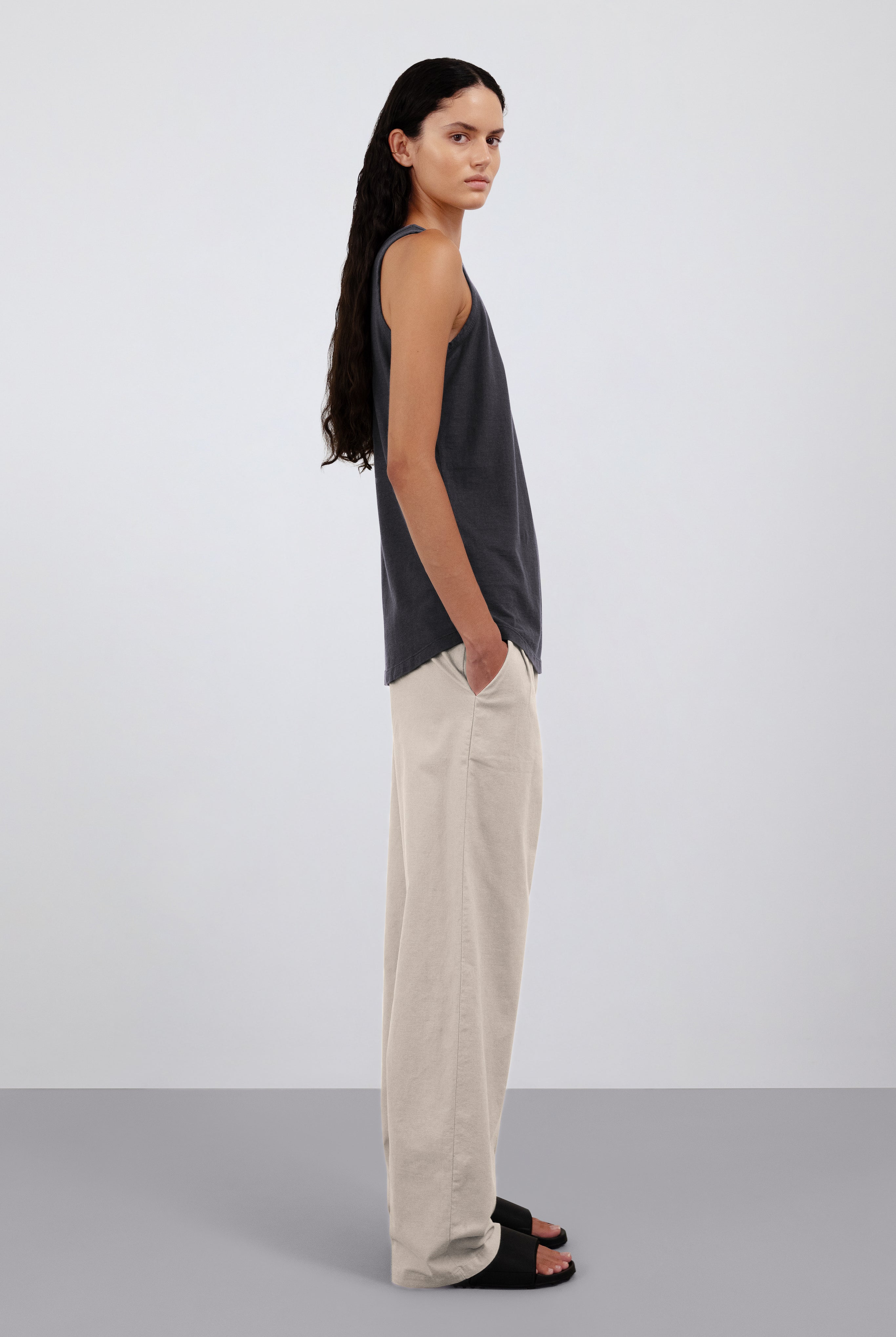 The Selene in Pitch Black. Shown on model. 140 grams organic cotton. GOTS certified. Shown with the Alex in Beige.
