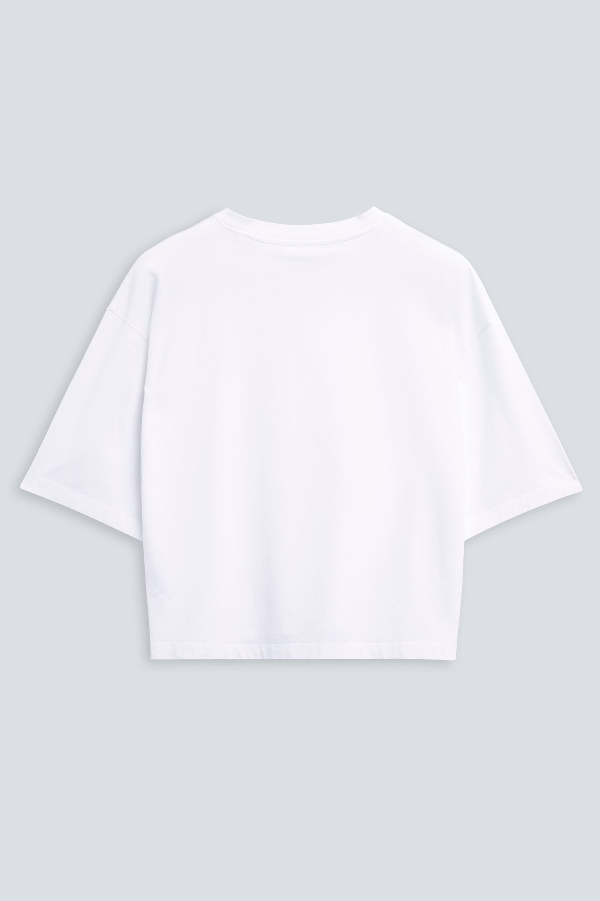The Talia in Crispy White. Dropped shoulders and mid-length sleeves. 180 grams, 100% organic cotton. Back view.