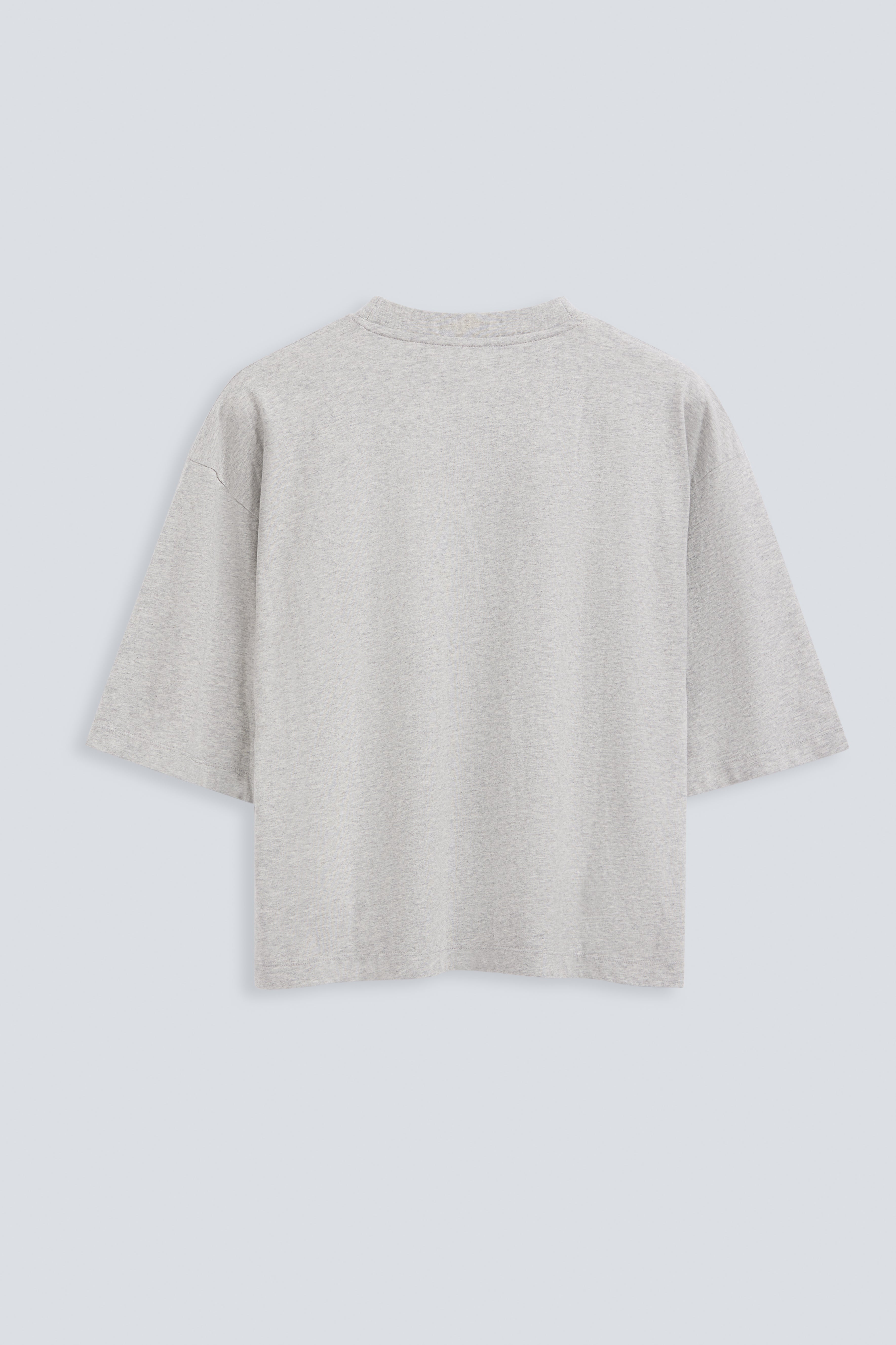 The Talia in Grey Melange. Back view. Dropped shoulders and mid-length sleeves, 180g, 100% organic cotton made in Portugal. GOTS