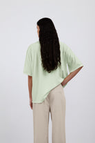 The Alex in Beige. 50% linen with 48% cotton with 2% elastane. Shown on model with The Lara in Lime. Back view. 