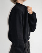 The Pippa bomber jacket in essential black on model, organic cotton fleece