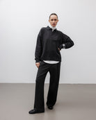 The Riley in Pitch Black. 100% organic cotton babyfleece. GOTS certified. Shown on model with The Theresa in Off-White & The Remi in Pitch Black. 