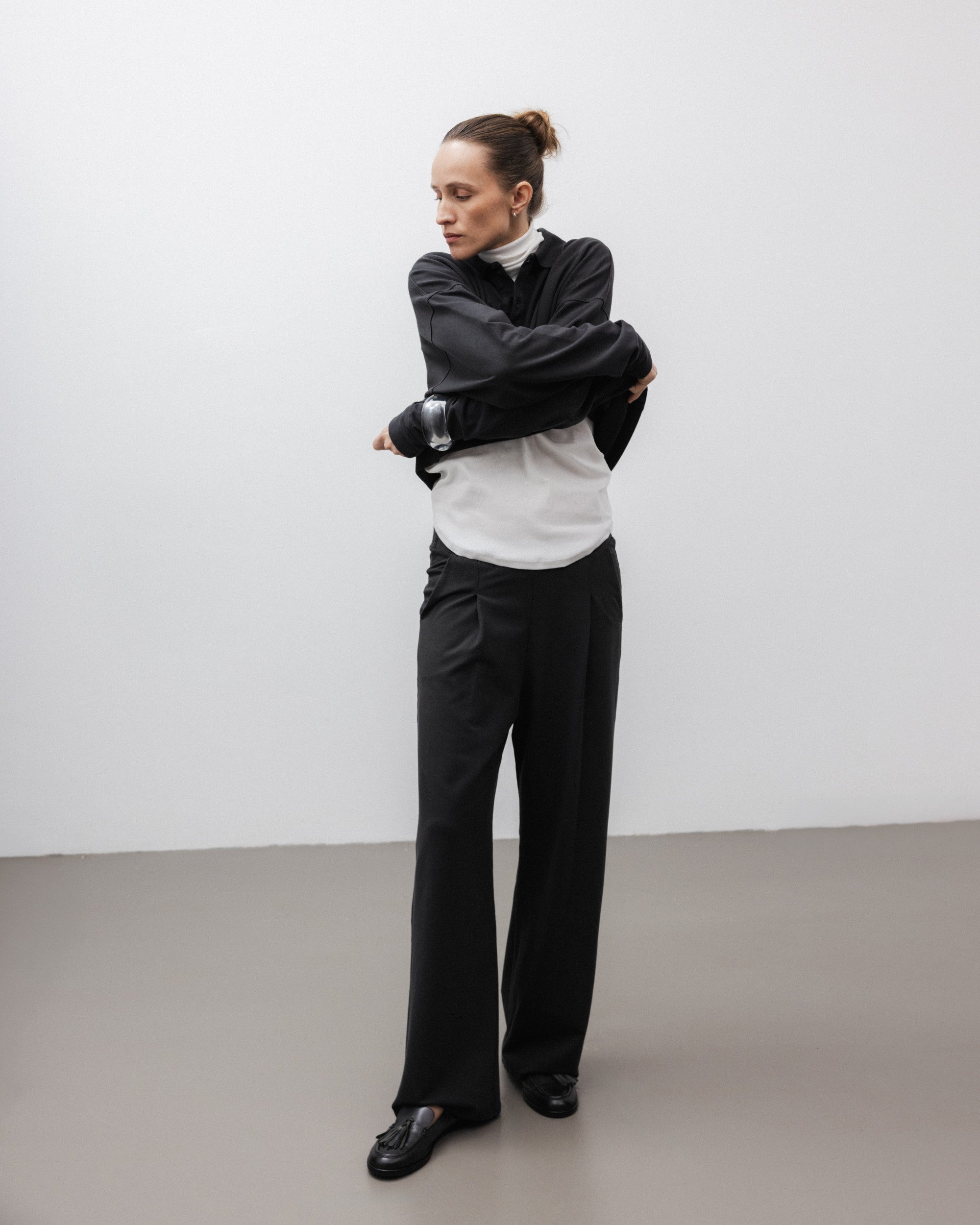 The Theresa in Off-White. Ribbed Turtleneck. 95% organic cotton with 5% elastane. GOTS. Shown on model with The Remi in Pitch Black. 