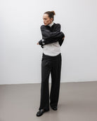 The Theresa in Off-White. Ribbed Turtleneck. 95% organic cotton with 5% elastane. GOTS. Shown on model with The Remi in Pitch Black. 