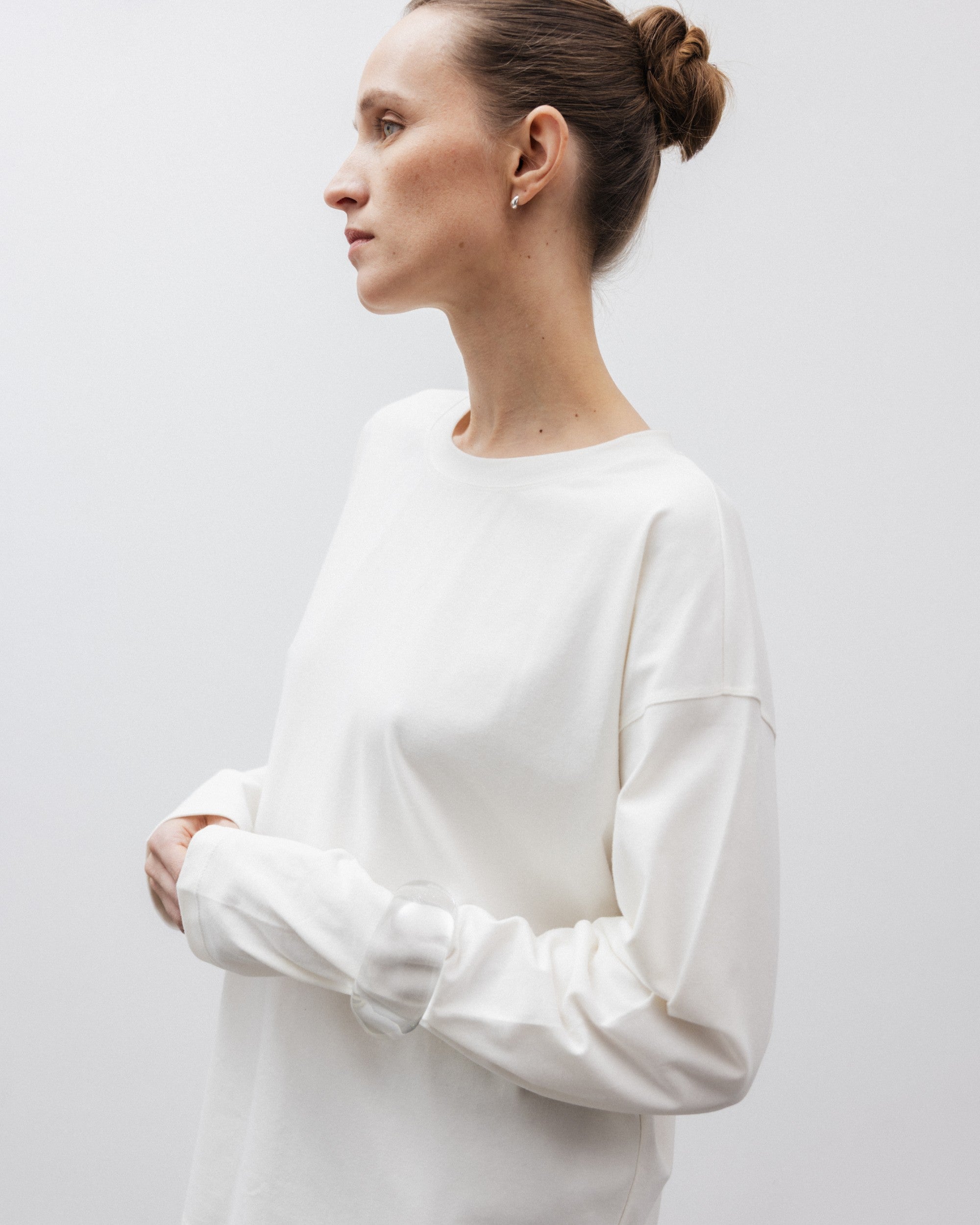 The Rose in Off-White. An oversized long sleeve that wears like a sweater, but lighter. 95% organic cotton with 5% elastane. GOTS. Shown on model. 