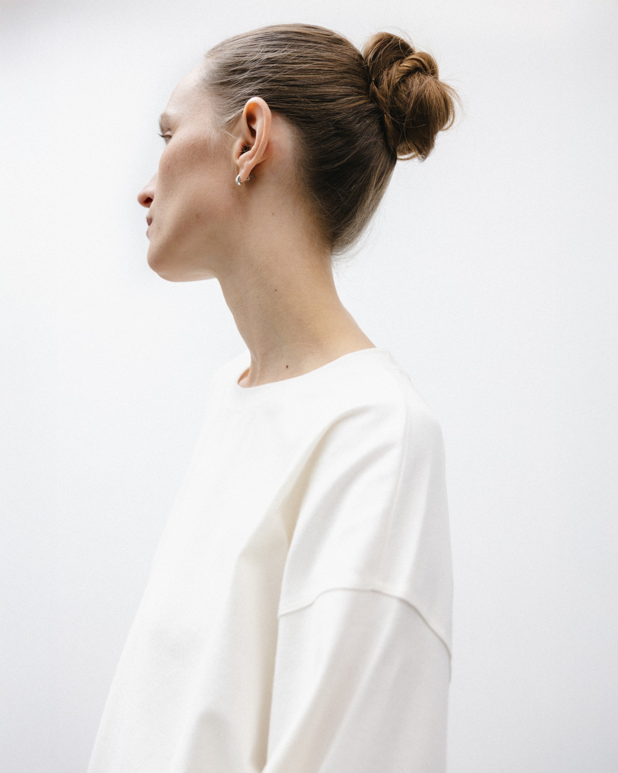 The Rose in Off-White. An oversized long sleeve that wears like a sweater, but lighter. 95% organic cotton with 5% elastane. GOTS. Shown on model. 