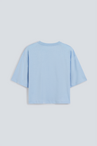 The Talia blue fog tee back view, dropped shoulders and mid-length sleeves, 180g organic cotton made in Portugal