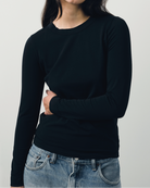 The Nora fitted long sleeve in essential black on model, organic cotton with stretch
