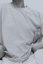 The Tess grey melange tee detail view on model, dropped shoulders