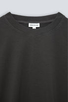 The May in Pitch Black. Crew-neck sweater with a boxy shape. 100% organic cotton babyfleece. GOTS. Collar detail. 