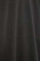 The May in Pitch Black. Crew-neck sweater with a boxy shape. 100% organic cotton babyfleece. GOTS. Material detail. 