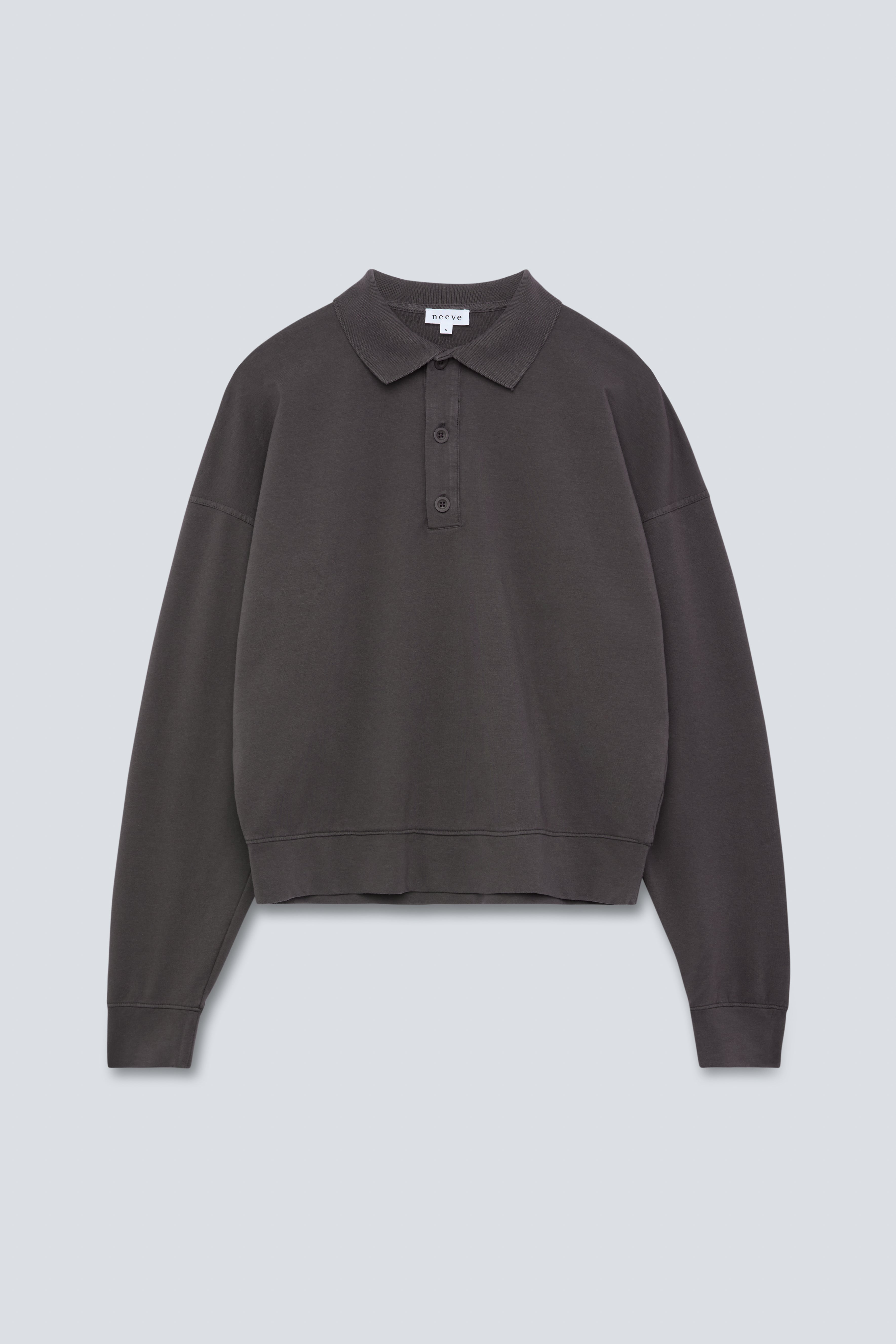 The Remi in Pitch Black. Polo long sleeve and a boxy shape.  Made from 100% organic cotton babyfleece. GOTS. Front view.