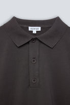 The Remi in Pitch Black. Polo long sleeve and a boxy shape.  Made from 100% organic cotton babyfleece. GOTS. Collar detail. 