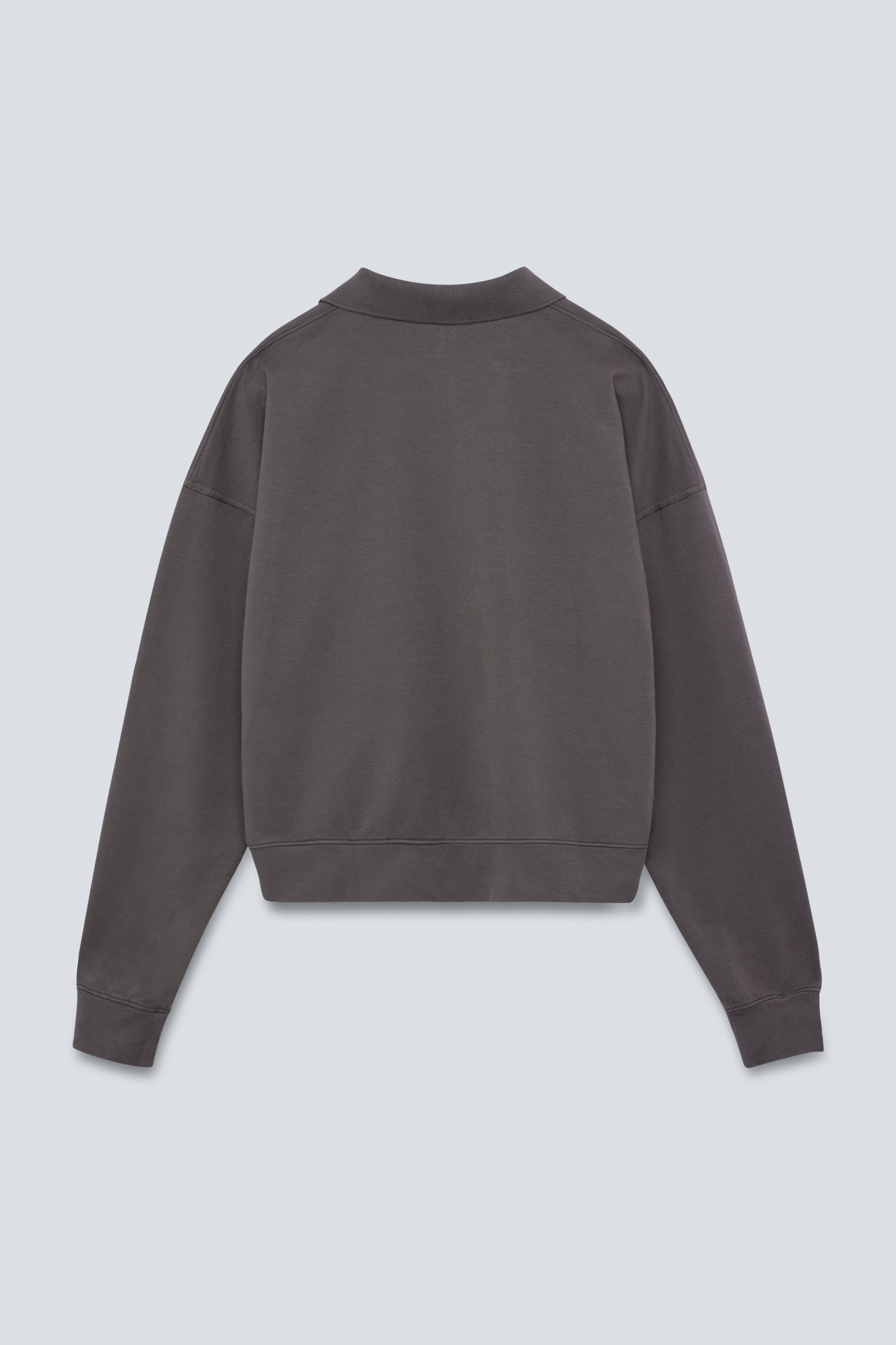 The Remi in Pitch Black. Polo long sleeve and a boxy shape.  Made from 100% organic cotton babyfleece. GOTS. Back View. 