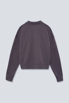 The Remi in Plum. Polo long sleeve with a boxy shape. Made from 100% organic cotton babyfleece. Back view.