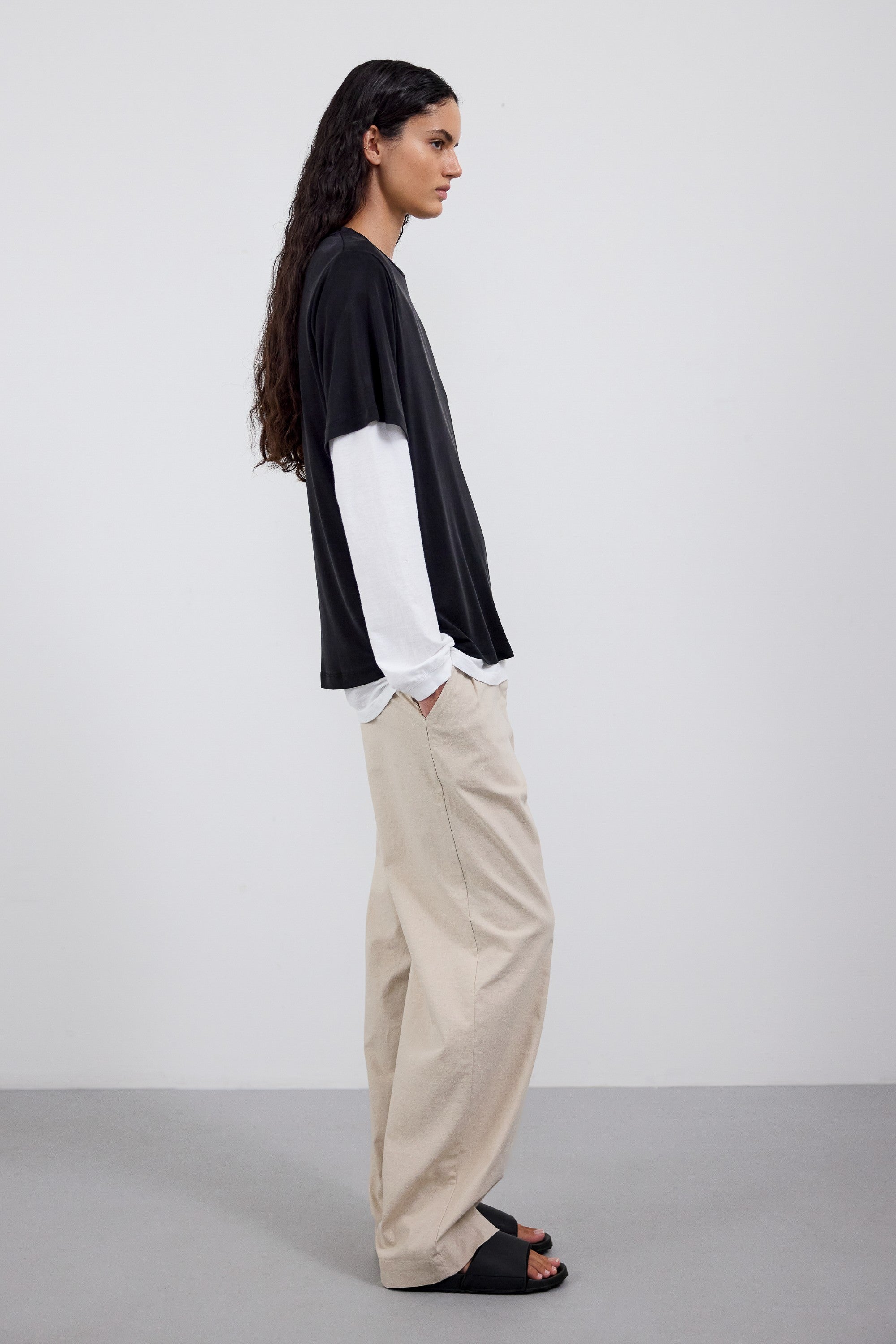 The Sadie in Essential Black. 100% Lyocell.  Shown on model with the Emily in Crispy White and The Alex in Beige. Side view. 