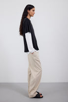 The Sadie in Essential Black. 100% Lyocell.  Shown on model with the Emily in Crispy White and The Alex in Beige. Side view. 