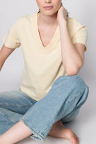 The Victoria cropped v-neck in apricot on model, GOTS certified organic cotton