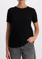 The Michelle crew-neck t-shirt in essential black shown on model, GOTS certified organic cotton
